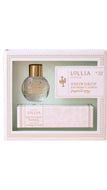 Lollia No. 32 Snowdrop Fragrance Set in a light pink gift box with a clear window, showing a round glass bottle with a gold cap and a matching box inside.