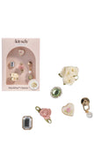 Kitsch charm set with various decorative charms on a white background
