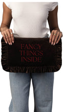 Load image into Gallery viewer, A person wearing a white top and light blue jeans holds a dark brown velvet clutch or pouch with ruffled edges. The front features the phrase 'FANCY THINGS INSIDE' in red serif lettering.
