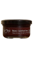 A glass jar of Eat This! Farms Balsamic Caramelized Onions with a dark brown label and black lid, set against a plain white background.