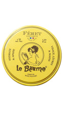 Load image into Gallery viewer, A round yellow tin of Férét Le Baume Rose Poudrée perfume balm, featuring a vintage illustration of a woman holding a mirror on the lid, set against a plain white background.
