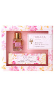 Lollia Tea Treehouse fragrance gift set featuring a small perfume bottle with a gold cap and a hand cream tube, both in floral pink packaging, presented in a matching floral box.