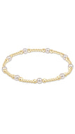 Pearl bracelet with gold accents on a white background
