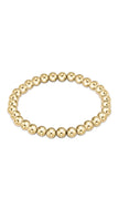 Gold beaded bracelet on a white background