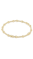 Gold beaded bracelet on a white background