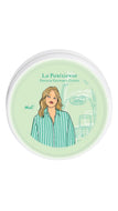 A round white-lidded jar of La Parisienne French Gourmet Candy, featuring a light green label with an illustration of a woman in a green striped shirt.